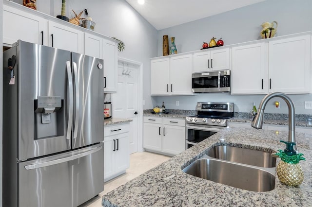 4321 NW 34th Ln, Cape Coral, FL 33993 - kitchen with stainless steel appliances, white cabinets, and light stone countertops
