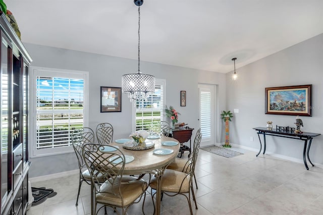 4321 NW 34th Ln, Cape Coral, FL 33993 - dining area with vaulted ceiling, a chandelier, and light tile patterned floors