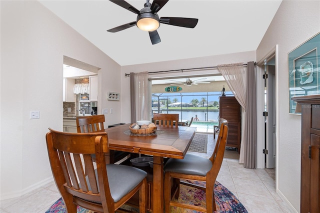 4142 Reif Ct, Port Charlotte, FL 33981 - dining room featuring ceiling fan, vaulted ceiling, light tile patterned floors, and a water view