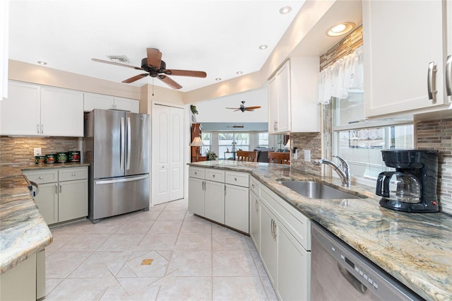 4142 Reif Ct, Port Charlotte, FL 33981 - kitchen with stainless steel appliances, a ceiling fan, backsplash, light stone counters, and recessed lighting