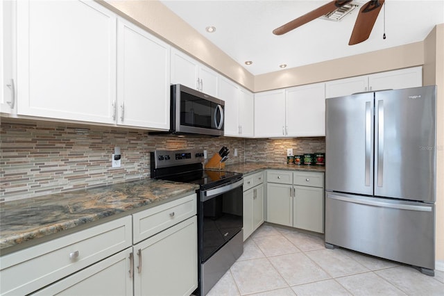 4142 Reif Ct, Port Charlotte, FL 33981 - kitchen featuring appliances with stainless steel finishes, a ceiling fan, white cabinetry, and decorative backsplash