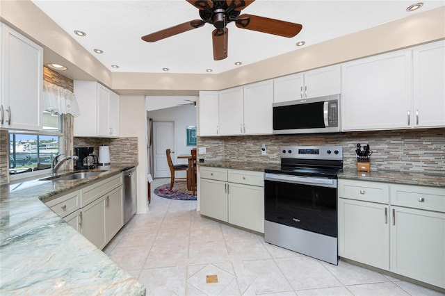 4142 Reif Ct, Port Charlotte, FL 33981 - kitchen featuring stainless steel appliances, a ceiling fan, stone counters, tasteful backsplash, and white cabinets