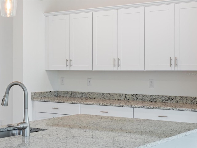 2161 Gardenia Ave, Port Charlotte, FL 33953 - kitchen with white cabinetry and light stone countertops