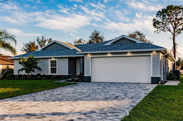 627 SE 22nd Ter, Cape Coral, FL 33990 - ranch-style home featuring decorative driveway, a front yard, an attached garage, and a shingled roof