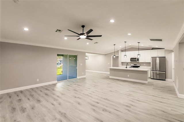 627 SE 22nd Ter, Cape Coral, FL 33990 - unfurnished living room featuring recessed lighting, lofted ceiling, light wood finished floors, crown molding, and a ceiling fan