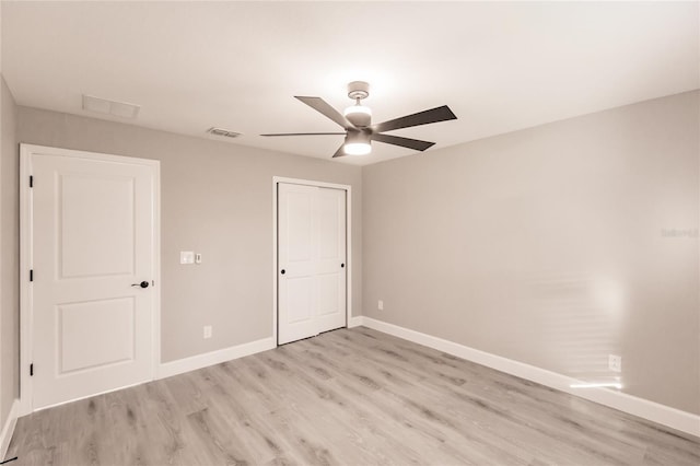 627 SE 22nd Ter, Cape Coral, FL 33990 - unfurnished bedroom with light wood-type flooring, a closet, and a ceiling fan