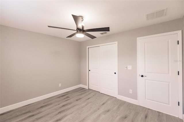 627 SE 22nd Ter, Cape Coral, FL 33990 - unfurnished bedroom featuring light wood-type flooring, a closet, and a ceiling fan