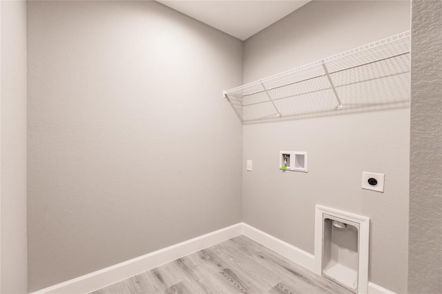627 SE 22nd Ter, Cape Coral, FL 33990 - laundry area with electric dryer hookup, washer hookup, and light wood finished floors