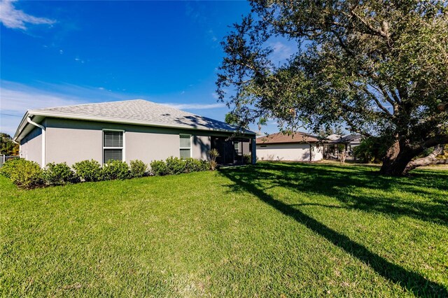 627 SE 22nd Ter, Cape Coral, FL 33990 - back of property featuring a lawn and stucco siding