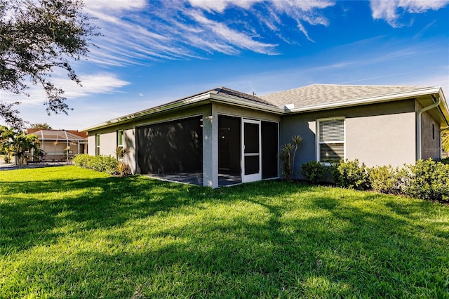 627 SE 22nd Ter, Cape Coral, FL 33990 - rear view of house featuring a sunroom, stucco siding, and a lawn