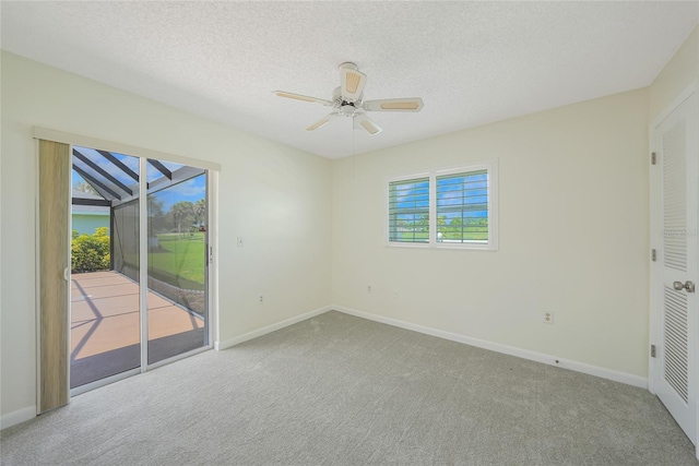 1915 Pebble Beach Ct, Venice, FL 34293 - unfurnished bedroom with access to exterior, carpet floors, a textured ceiling, and ceiling fan