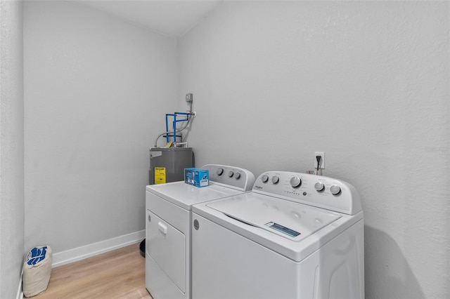 9155 Agate St, Port Charlotte, FL 33981 - laundry area featuring water heater, washing machine and dryer, and light wood-style flooring