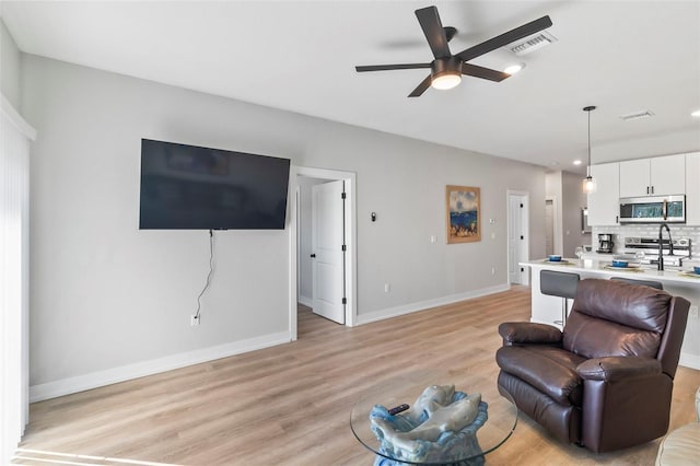 9155 Agate St, Port Charlotte, FL 33981 - living room featuring light wood-type flooring, a ceiling fan, and recessed lighting