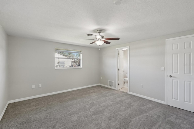 1107 Seneca Rd, Venice, FL 34293 - unfurnished bedroom with carpet flooring, a textured ceiling, ensuite bath, and ceiling fan