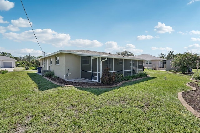 1107 Seneca Rd, Venice, FL 34293 - rear view of property with a sunroom, a lawn, and stucco siding