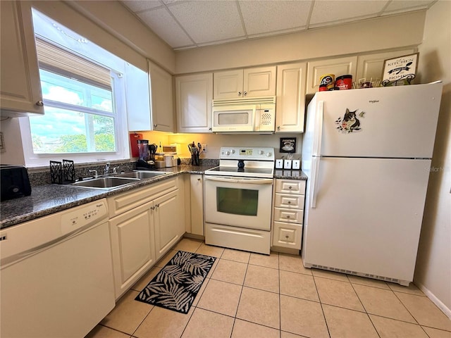 3116 Harbor Blvd Unit 3B, Port Charlotte, FL 33952 - kitchen featuring white appliances, a paneled ceiling, dark countertops, and light tile patterned floors