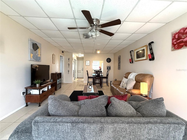 3116 Harbor Blvd Unit 3B, Port Charlotte, FL 33952 - living area with light tile patterned floors, ceiling fan, and a drop ceiling