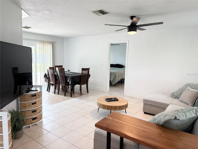 24 Charwood Cir, Lehigh Acres, FL 33936 - living room featuring light tile patterned floors, a ceiling fan, and a textured ceiling