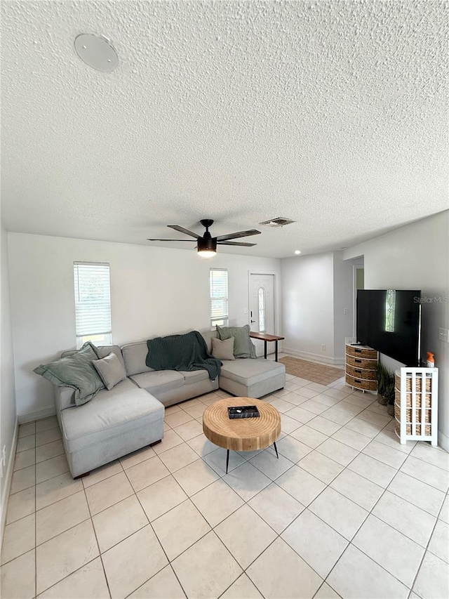 24 Charwood Cir, Lehigh Acres, FL 33936 - living area with ceiling fan, a textured ceiling, and light tile patterned floors