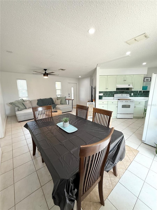 24 Charwood Cir, Lehigh Acres, FL 33936 - dining room featuring a textured ceiling, ceiling fan, and light tile patterned floors