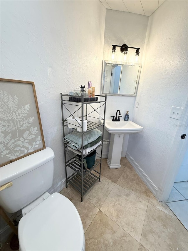 24 Charwood Cir, Lehigh Acres, FL 33936 - half bathroom featuring a textured wall and tile patterned flooring