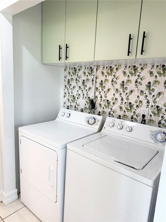 24 Charwood Cir, Lehigh Acres, FL 33936 - laundry room featuring washer and dryer, cabinet space, and light tile patterned flooring