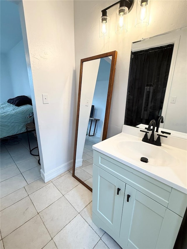 24 Charwood Cir, Lehigh Acres, FL 33936 - bathroom featuring vanity, tile patterned floors, and ensuite bathroom