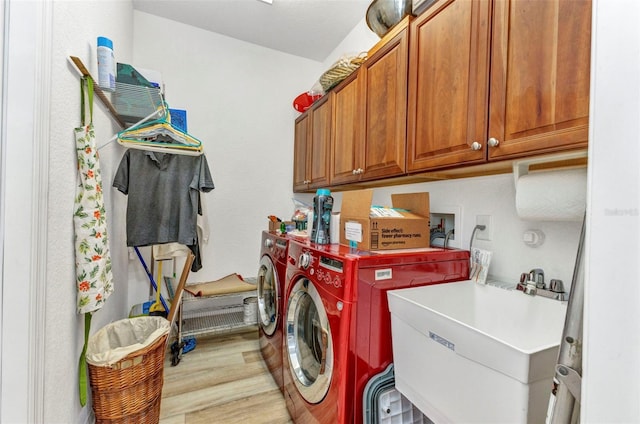 24504 Buckingham Way, Punta Gorda, FL 33980 - washroom featuring cabinet space, washer and dryer, and light wood-style floors