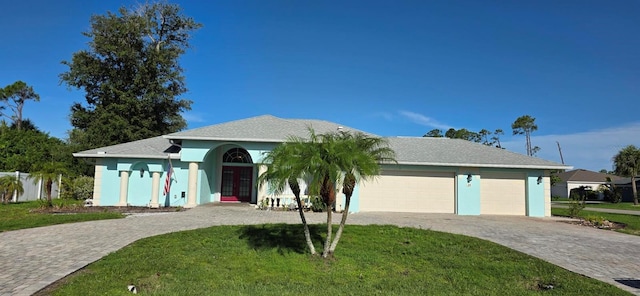 39 Norman St, Port Charlotte, FL 33954 - ranch-style house featuring french doors, a garage, decorative driveway, a front lawn, and stucco siding