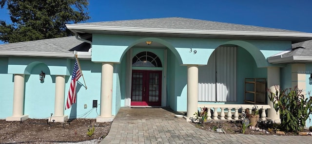39 Norman St, Port Charlotte, FL 33954 - entrance to property featuring french doors, a shingled roof, and stucco siding