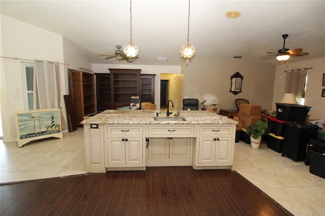 39 Norman St, Port Charlotte, FL 33954 - kitchen with ceiling fan, open floor plan, light stone countertops, and light wood-style flooring