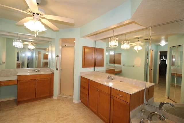 39 Norman St, Port Charlotte, FL 33954 - full bathroom featuring ceiling fan, a shower stall, two vanities, and tile patterned floors