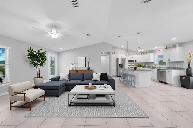 12112 Helios Ave, Port Charlotte, FL 33981 - living room featuring healthy amount of natural light, lofted ceiling, a ceiling fan, light tile patterned floors, and recessed lighting