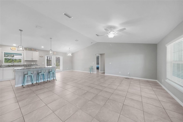 12112 Helios Ave, Port Charlotte, FL 33981 - unfurnished living room featuring vaulted ceiling, a ceiling fan, light tile patterned floors, and recessed lighting
