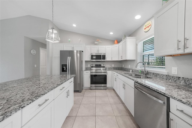 12112 Helios Ave, Port Charlotte, FL 33981 - kitchen featuring appliances with stainless steel finishes, lofted ceiling, white cabinetry, light stone countertops, and recessed lighting
