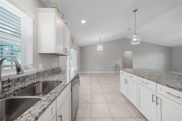 12112 Helios Ave, Port Charlotte, FL 33981 - kitchen with stainless steel dishwasher, vaulted ceiling, white cabinetry, decorative light fixtures, and light tile patterned floors