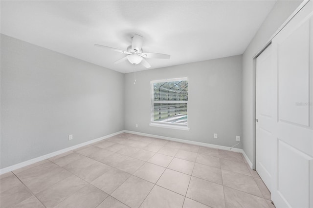 12112 Helios Ave, Port Charlotte, FL 33981 - unfurnished bedroom with a closet, a ceiling fan, and light tile patterned flooring