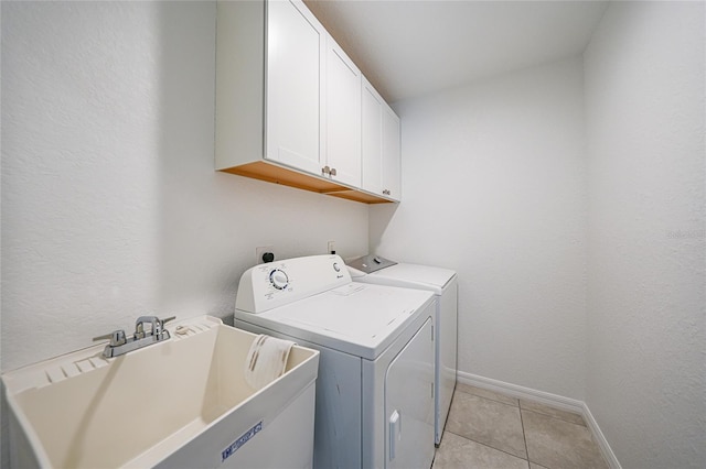 12112 Helios Ave, Port Charlotte, FL 33981 - laundry room with cabinet space, washer and clothes dryer, and light tile patterned flooring