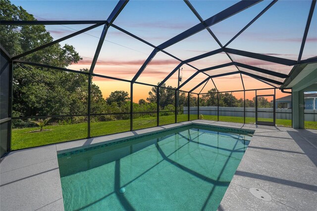 12112 Helios Ave, Port Charlotte, FL 33981 - swimming pool featuring a lawn, glass enclosure, and a patio