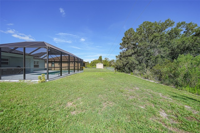 12112 Helios Ave, Port Charlotte, FL 33981 - view of grassy yard featuring a storage unit, an outdoor pool, and glass enclosure