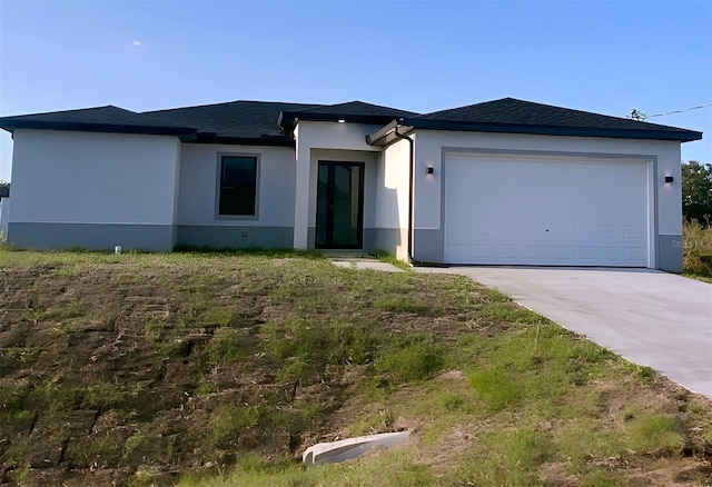 3113 58th, Lehigh Acres, FL 33971 - view of front facade with stucco siding, concrete driveway, a garage, and a shingled roof