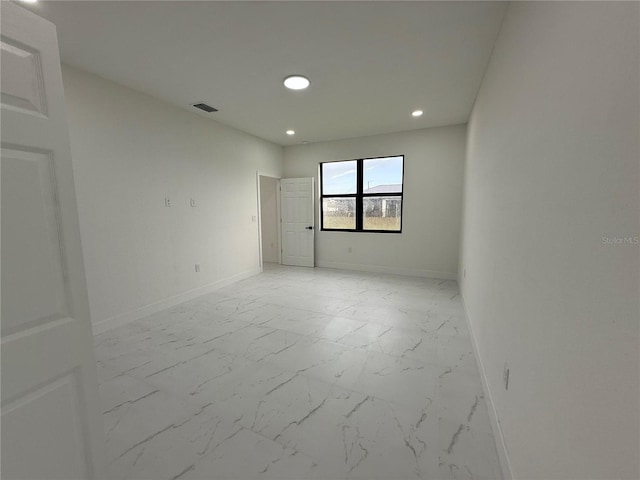 3113 58th, Lehigh Acres, FL 33971 - empty room with light marble finish flooring and recessed lighting