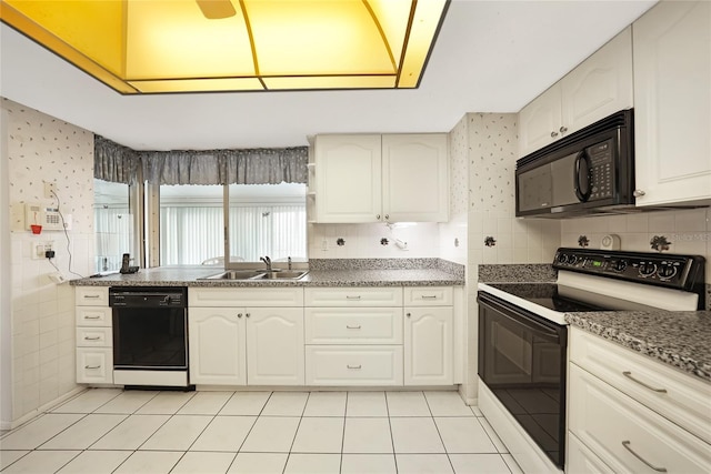 475 Whippoorwill Dr, Venice, FL 34293 - kitchen with black appliances, light tile patterned floors, white cabinetry, decorative backsplash, and wallpapered walls