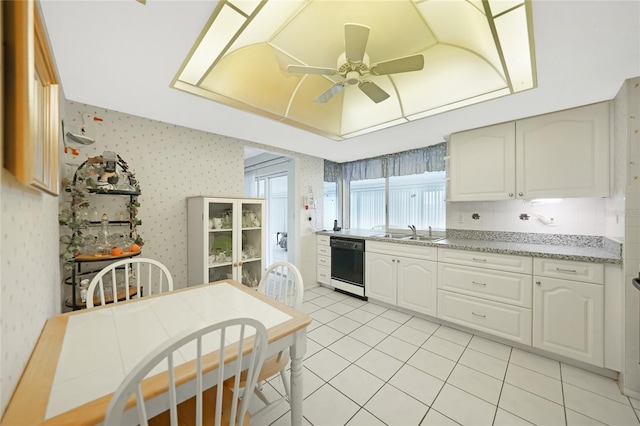475 Whippoorwill Dr, Venice, FL 34293 - kitchen featuring black dishwasher, a raised ceiling, ceiling fan, wallpapered walls, and light tile patterned floors