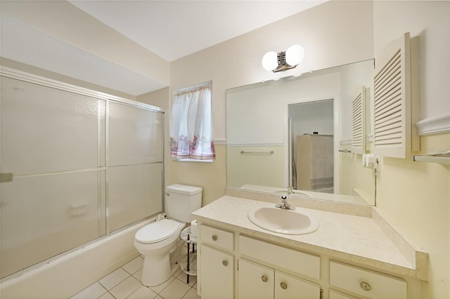 475 Whippoorwill Dr, Venice, FL 34293 - bathroom with vanity, tile patterned floors, and bath / shower combo with glass door