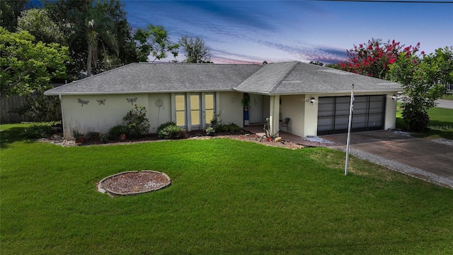 475 Whippoorwill Dr, Venice, FL 34293 - ranch-style house with a garage, stucco siding, driveway, and a front yard
