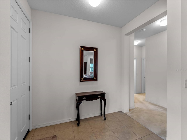 8814 Tuscany Isles Dr, Punta Gorda, FL 33950 - hallway with light tile patterned floors