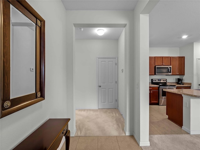 8814 Tuscany Isles Dr, Punta Gorda, FL 33950 - corridor featuring light colored carpet and light tile patterned floors