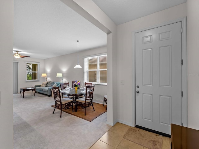 8814 Tuscany Isles Dr, Punta Gorda, FL 33950 - dining space featuring light colored carpet, a ceiling fan, and light tile patterned flooring