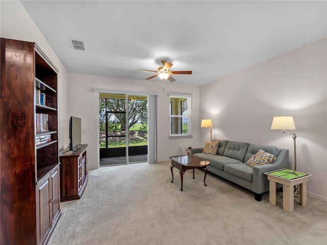 8814 Tuscany Isles Dr, Punta Gorda, FL 33950 - living area featuring ceiling fan and light carpet